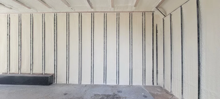 Interior with spray foam insulation in agricultural unit.