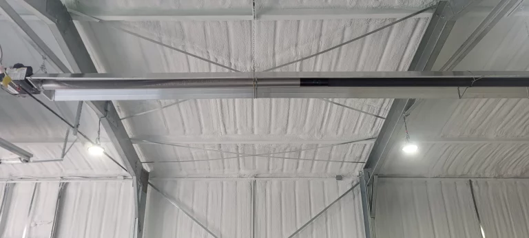 Metal building ceiling with spray foam insulation