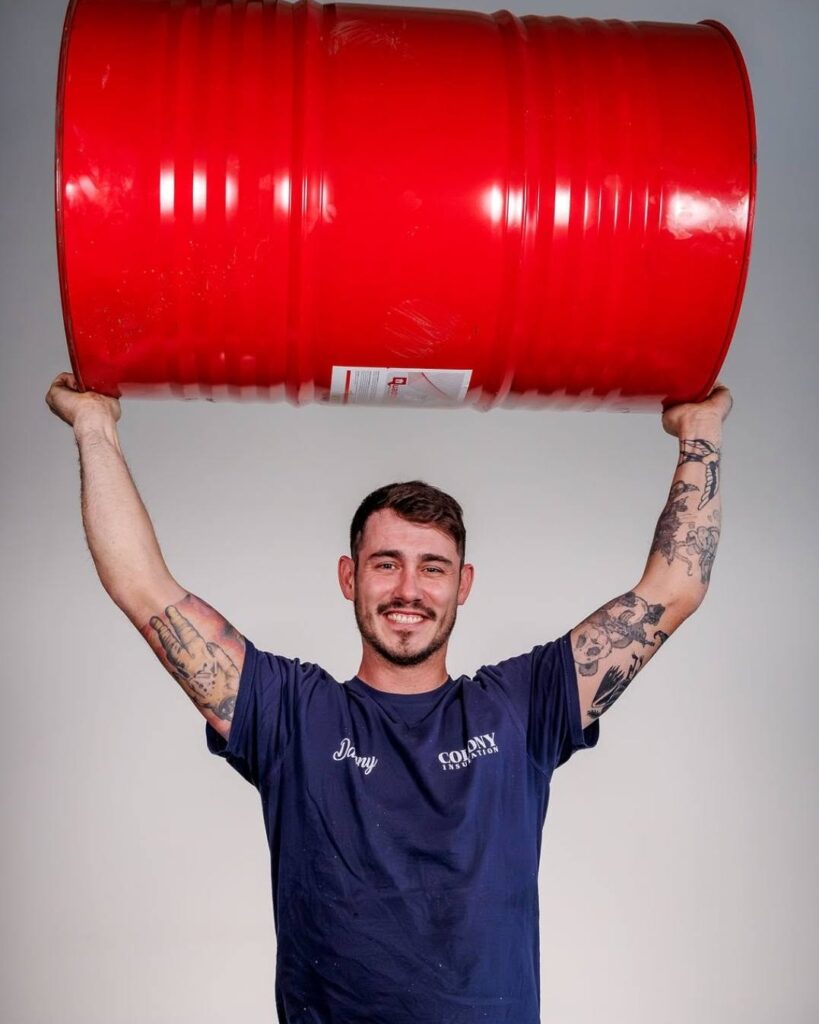 Danny Walker of Colony Insulation lifting barrel over head