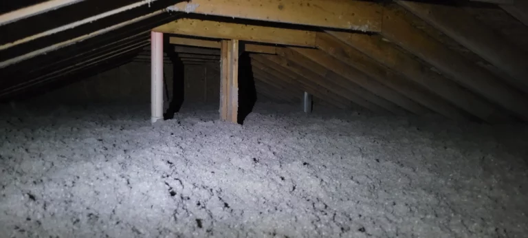 Blown-in attic insulation installed to improve home energy efficiency and thermal performance
