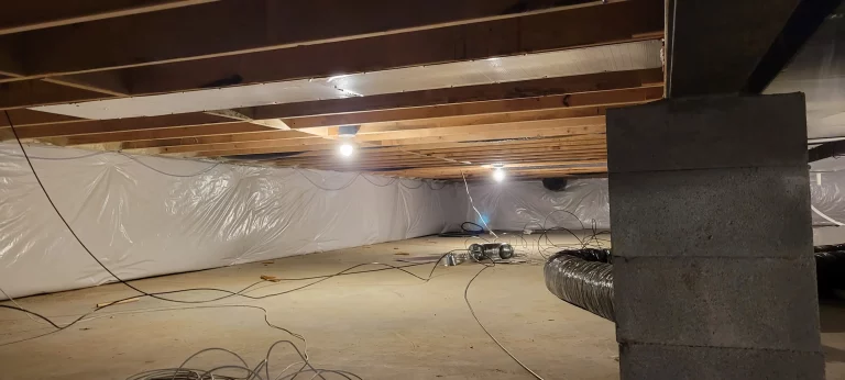 Encapsulated crawl space with wall vapor barrier installed to control moisture and improve energy efficiency