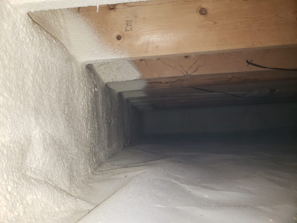 Crawl space insulation system featuring spray foam air sealing and vapor barrier installation to improve comfort and reduce moisture issues