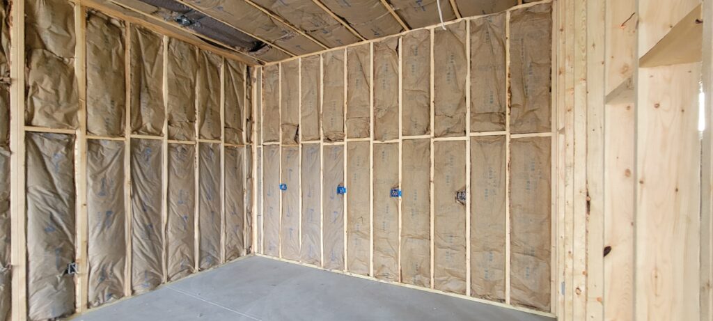 Fiberglass batt insulation installed in wall cavities to improve energy efficiency, sound control, and indoor comfort